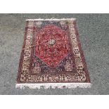 A Ghasghai rug, South West Persia, the madder field with a central octagonal medallion,