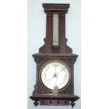 A Victorian carved oak wall barometer, with a 19cm diameter dial, height 77cm, width 33cm.