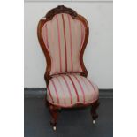A Victorian walnut lady's salon chair, the leaf carved top rail,