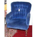 A Victorian tub armchair, the button upholstered back, padded arms and seat on turned tapering legs.