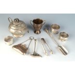 An Indian silver bachelors tea pot, a silver purse a small silver trophy and a little electro plate.