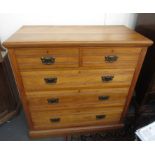 An Edwardian satin walnut chest of drawers with two short and three long drawers on a plinth base,