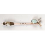 An opal and diamond stick pin.