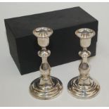 A pair of modern filled silver candlesticks with detachable nozzles, height 18.