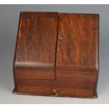 A Victorian oak stationary cabinet, the pair of doors opening to reveal a fitted interior,
