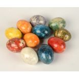 Eleven polished hardstone eggs, of various colours, 6.2 x 5cm.