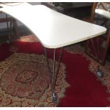 A B&B Cassina table with white wasted top, each tri-tubular leg with twin casters.
