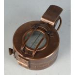 A military metal compass, inscribed T.G Ltd, London and dated 1940.