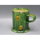 A Walter Keeler Studio Pottery mug, the 'Whieldon' style glaze in green and yellow, height 9.