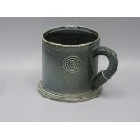 A Walter Keeler Studio Pottery saltglaze mug, the mottled body decorated with two roundels,