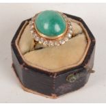 A good 18ct gold emerald and diamond ring the central cabochon oval emerald of approximately 6cts