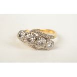 An 18ct gold four stone diamond crossover ring with diamond shoulders.