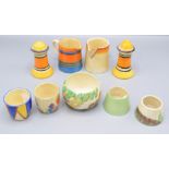 A pair of Clarice Cliff salt and pepper pots, height 8.5cm, two cream jugs and four egg cups.