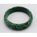 A Chinese carved spinach jade bangle.