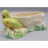 A Clarice Cliff planter, decorated with lovebirds perched on a leafy branch, length 26cm.
