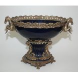 A gilt metal and blue porcelain centrepiece, the handles modelled as rearing horses, height 44cm,