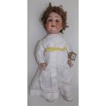 A porcelain head doll by Schoenau and Hoffmeister, the head with sleep eyes,