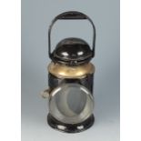 A brass and tin plate railway lantern, the handle twisting to operate the red,