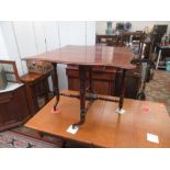 A Victorian walnut butterfly Sutherland table on turned tapering supports joined by turned