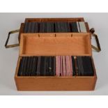 Two hardwood boxes containing a collection of coloured glass magic lantern slides including Alice