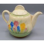 A Clarice Cliff 'Spring' crocus pattern teapot, height 14cm, width 18cm.