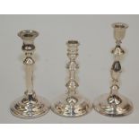 Three filled silver modern candlesticks each with circular base, one with detachable nozzle.
