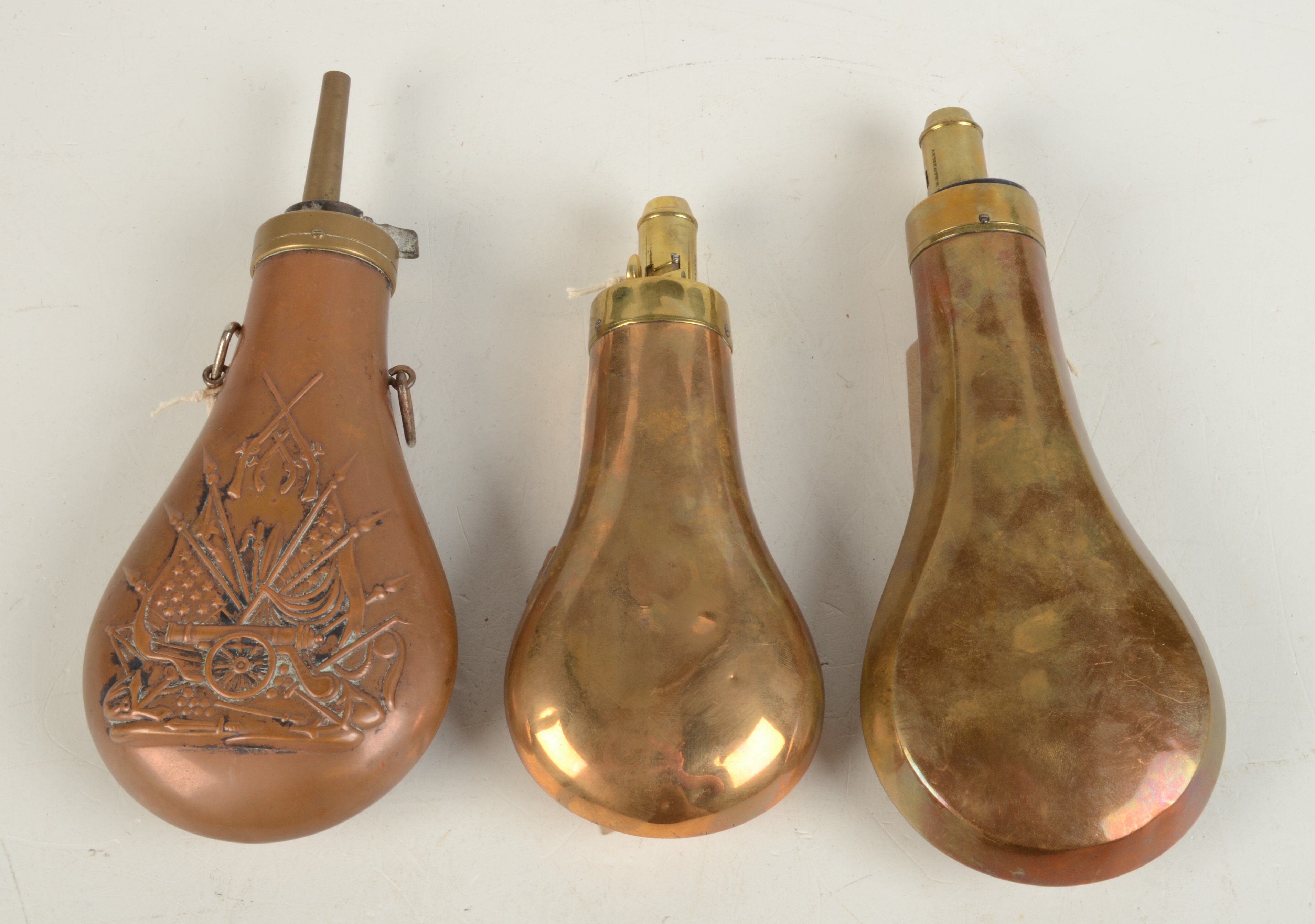Three copper powder flasks.