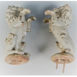 A pair of iron gate post finials each cast as a lion sejant erect and each height 31cm.