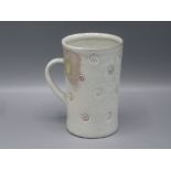 A Jim Malone Studio Pottery mug, the white glaze with incised roundels, height 12cm, diameter 8cm.