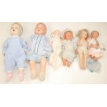 A collection of six vintage dolls in plastic and composition damage.