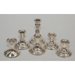 Two pairs of modern filled silver low candlesticks and two other filled silver low candlesticks.