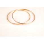 Two 18ct gold slave bangles, 16.9g.