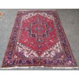 A Heriz carpet, North West Persia, the red field with a large lobed polychrome medallion,