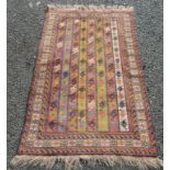 A South West Persian rug, the polychrome field with eight vertical columns containing guls,