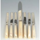 A bread knife with heavy silver blade and mother of pearl handle together with six fruit knives