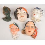 Five Art Deco style pottery and porcelain wall masks, modelled as lady's, largest length 18.5cm.