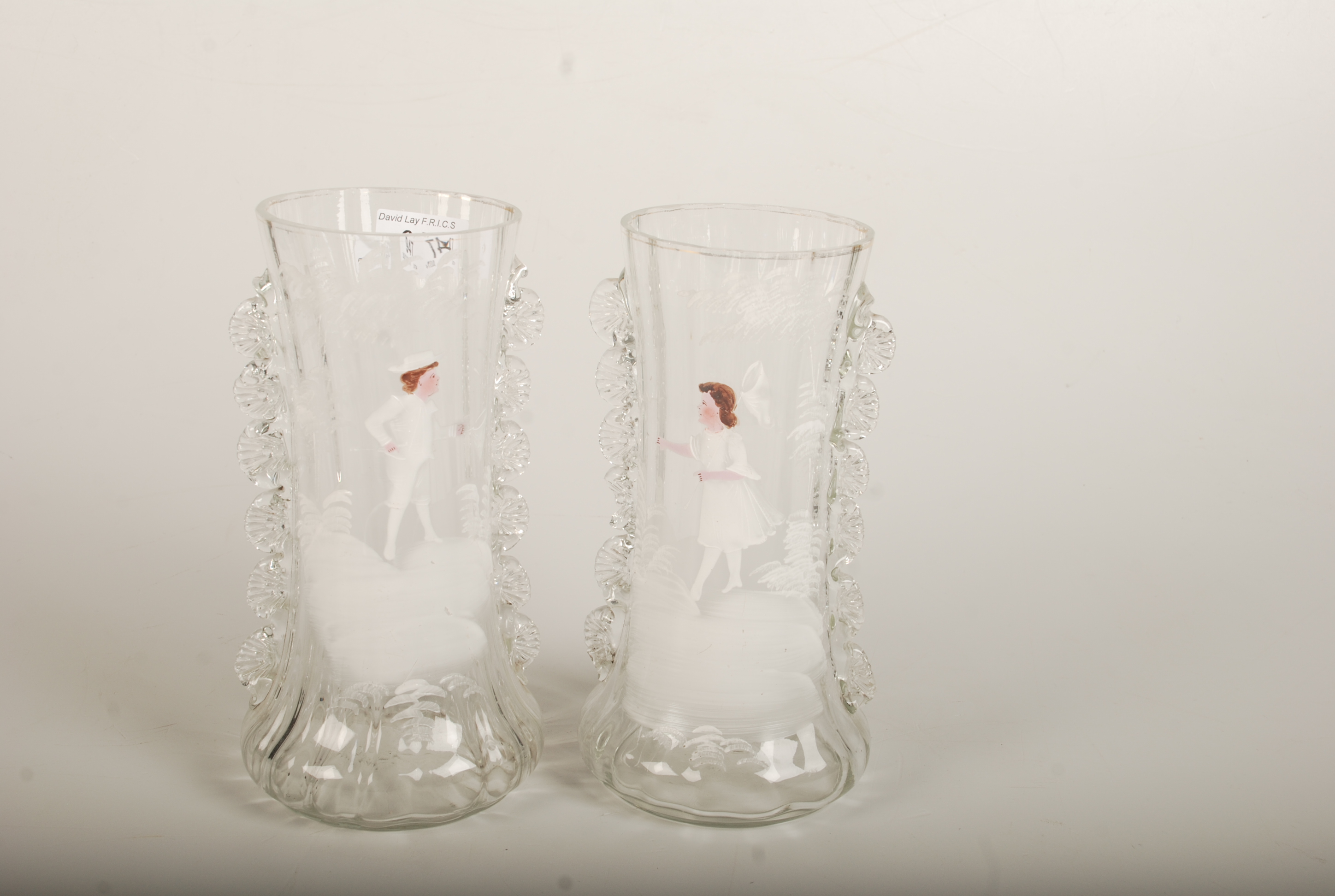 A pair of Mary Gregory glass vases, each painted with a child, height 22.5cm.
