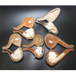 Five meerschaum pipes, one with attached sticker inscribed 'Admiral Meerschaum and Calabash',