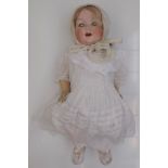 An Armand Marseille porcelain head doll, the head with sleep eyes,