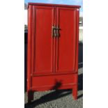 A Chinese red lacquered tapering cupboard,