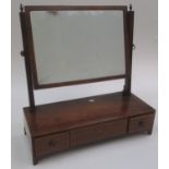 A mahogany dressing table mirror, 19th century, the rectangular plate on reeded supports,