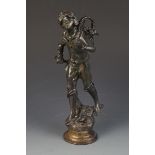 A bronze of a boy grape harvester standing on a naturalistic base, height 38cm.