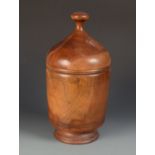 A large treen jar and cover, with a circular finial handle and footed base, height 40cm,