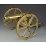 A bronze cannon, height 19cm, length 36cm.