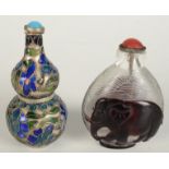 A Chinese silver and enamel snuff bottle decorated with flowers and trees, height 8cm,