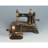 A late 19th/early 20th century 'Baby' miniature hand sewing machine the base marked J. C.