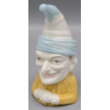 A Royal Worcester porcelain candle extinguisher, in the form of Mr Punch, height 9cm.