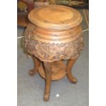 A Chinese hardwood jardiniere stand carved with flowering trees on downswept supports, height 61cm,