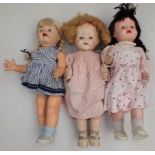 Three hard plastic walking dolls, one by the British National Dolls of London.