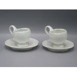 A pair of Joanna Howells porcelain cups and saucers, height of cup 6.7cm, diameter of saucers 14cm.